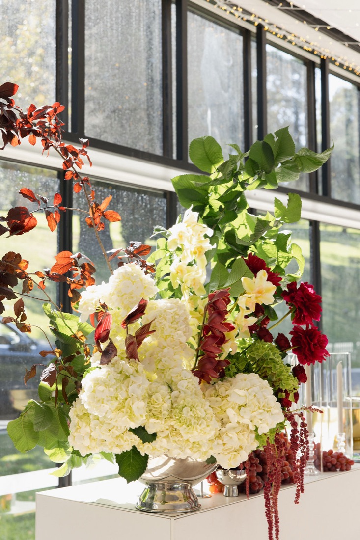 A sculptural floral arrangement on a dining table