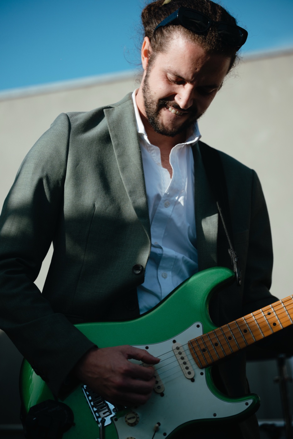 A guitarist in black tie playing at a reception